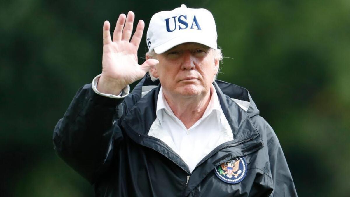 President Donald Trump waves as he walks away from Marine One as he arrives at the White House, Thursday, Sept. 14, 2017, in Washington. Trump is returning from Florida after viewing damage from Hurricane Irma.