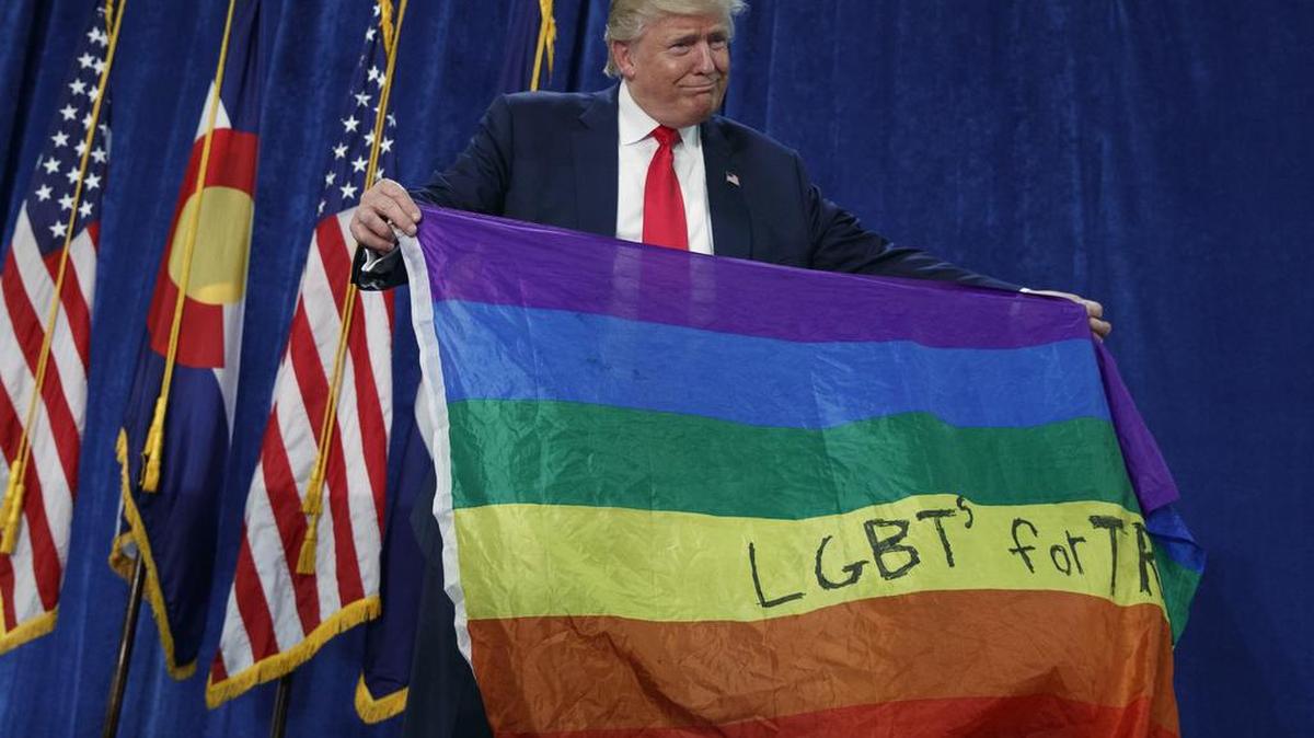 Republican presidential candidate Donald Trump holds a flag as he arrives to a campaign rally at the University of Northern Colorado, Sunday, Oct. 30, 2016, in Greeley, Colo.