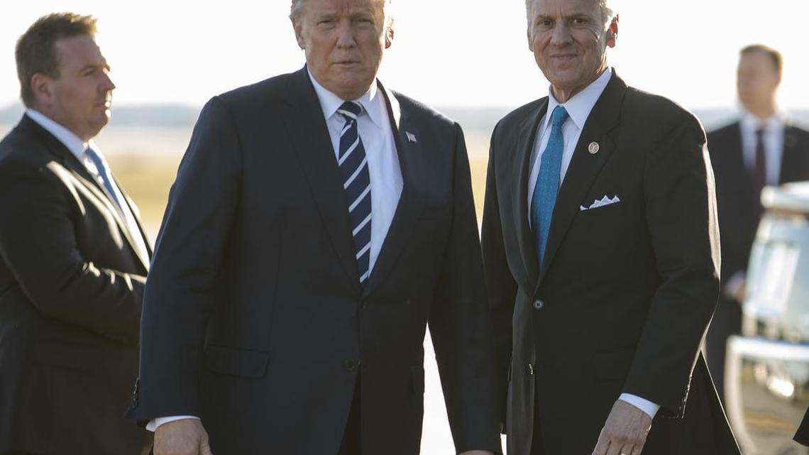 President Donald Trump stands on the tarmac with South Carolina Gov. Henry McMaster as he arrives on Air Force One at Greenville Spartanburg International Airport, in Greer, S.C., Monday.