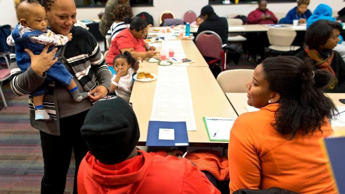 Dalvery Blackwell, co-founder of the African American Breastfeeding Network, talks with young mothers as she holds a baby from an attendee at a monthly gathering that promotes breast-feeding at a YMCA in Milwaukee. On Wednesday, the U.S. House will vote on a bill that would require the federal government to conduct more research into health risks faced by women who use medications while breast-feeding.