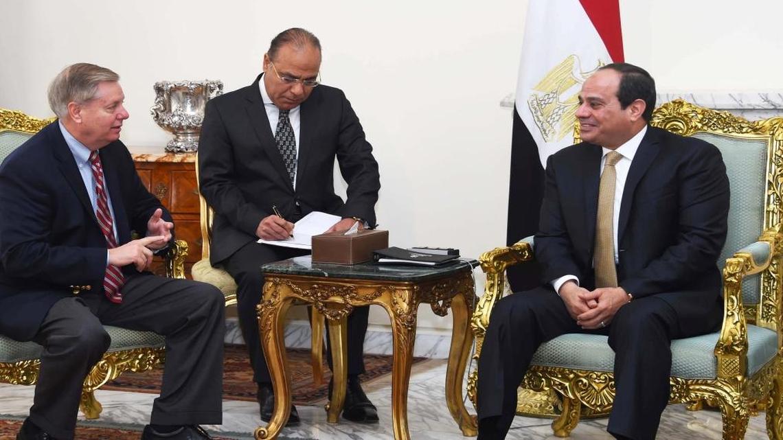 In this photo provided by Egypt's state news agency, MENA, Egyptian President Abdel-Fattah el-Sissi (right) meets with Republican Sen. Lindsey Graham (left) at the office of the presidency in Cairo.