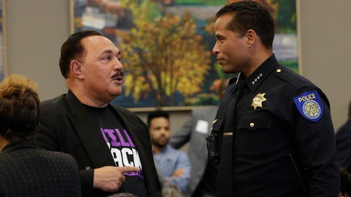 Sacramento Police chief Daniel Hahn, right, talks to an attendee of a meeting to discuss the fatal police shooting of Stephon Clark, at the Sacramento City Hall in Sacramento, Calif.