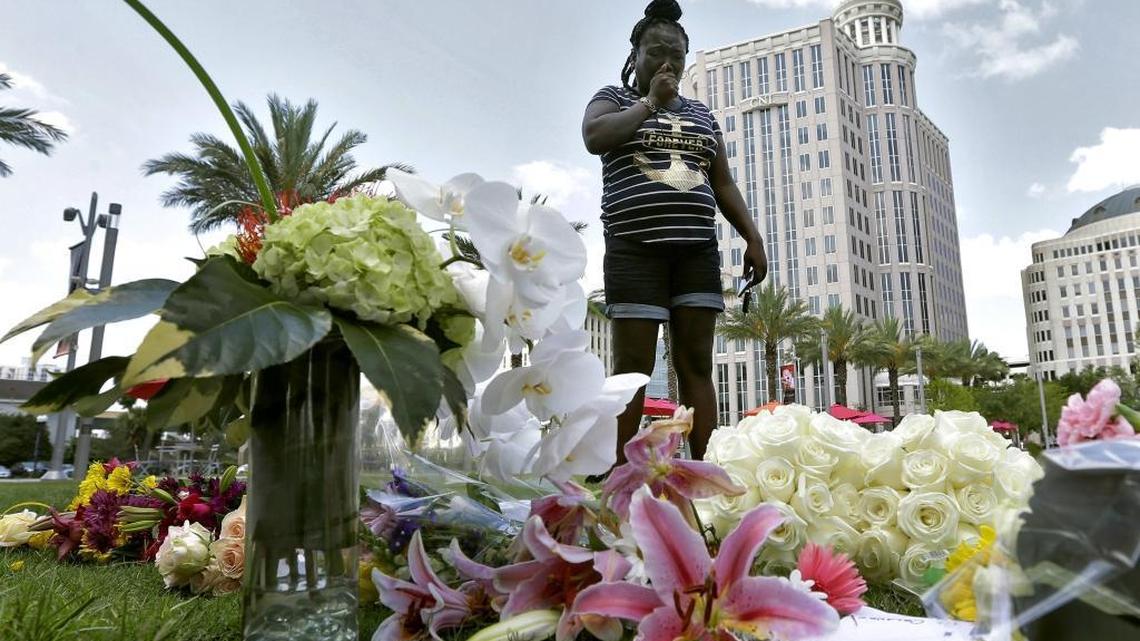 Krystle Martin weeps as she views a makeshift memorial Monday, June 13, 2016, for the victims of a fatal shooting at the Pulse Orlando nightclub in Orlando, Fla.
