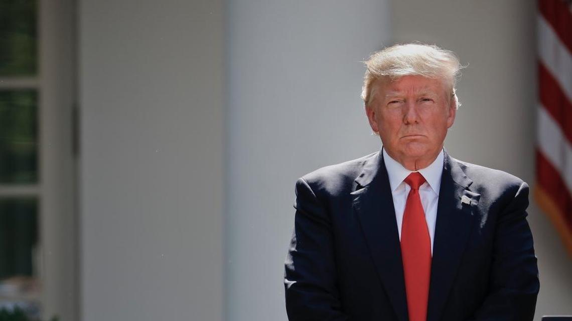 President Donald Trump stands next to the podium after speaking in the Rose Garden about the U.S. role in the Paris climate change accord,