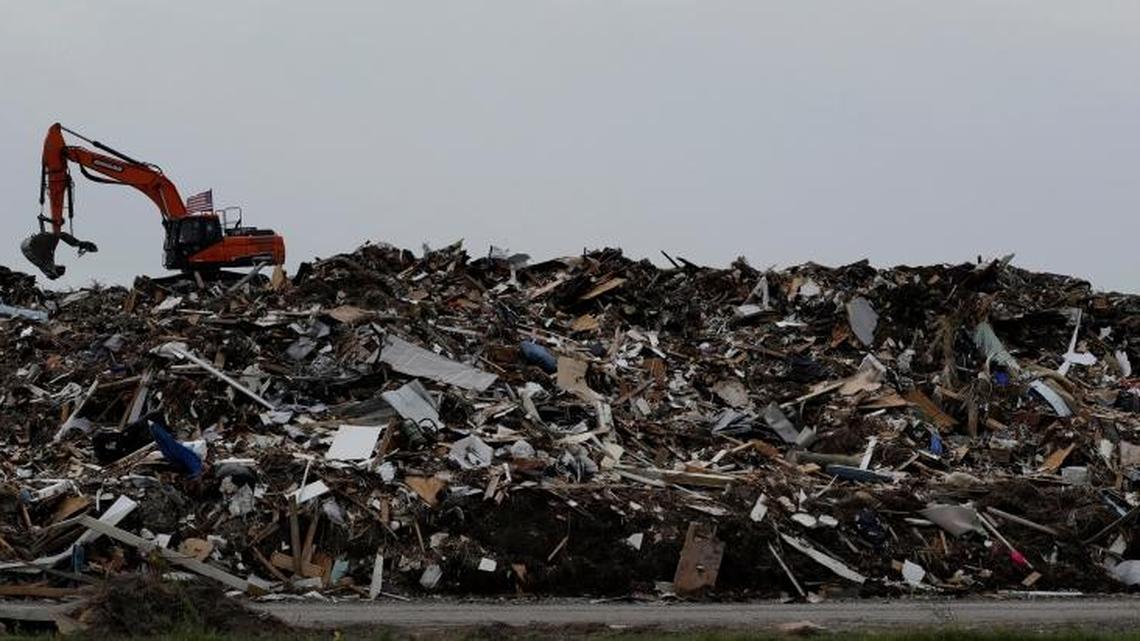 An excavator is used to move a mountain of debris created in the wake of Hurricane Harvey, Port Aransas, Texas. The storm damaged or destroyed 80 percent of local homes and businesses and arrived just before Labor Day, wiping out the lucrative summer season's final weeks.