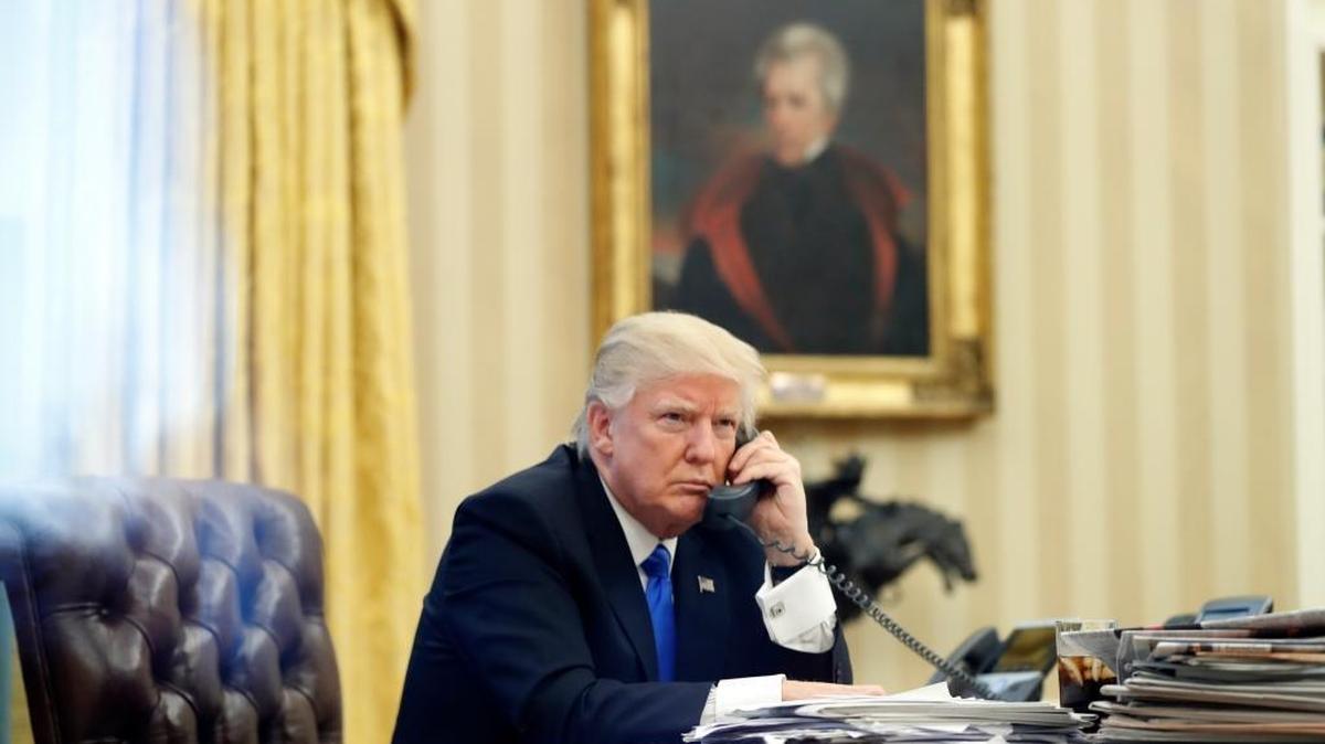 President Donald Trump speaks on the phone with Prime Minister of Australia Malcolm Turnbull in the Oval Office of the White House, Saturday, Jan. 28, 2017 in Washington.