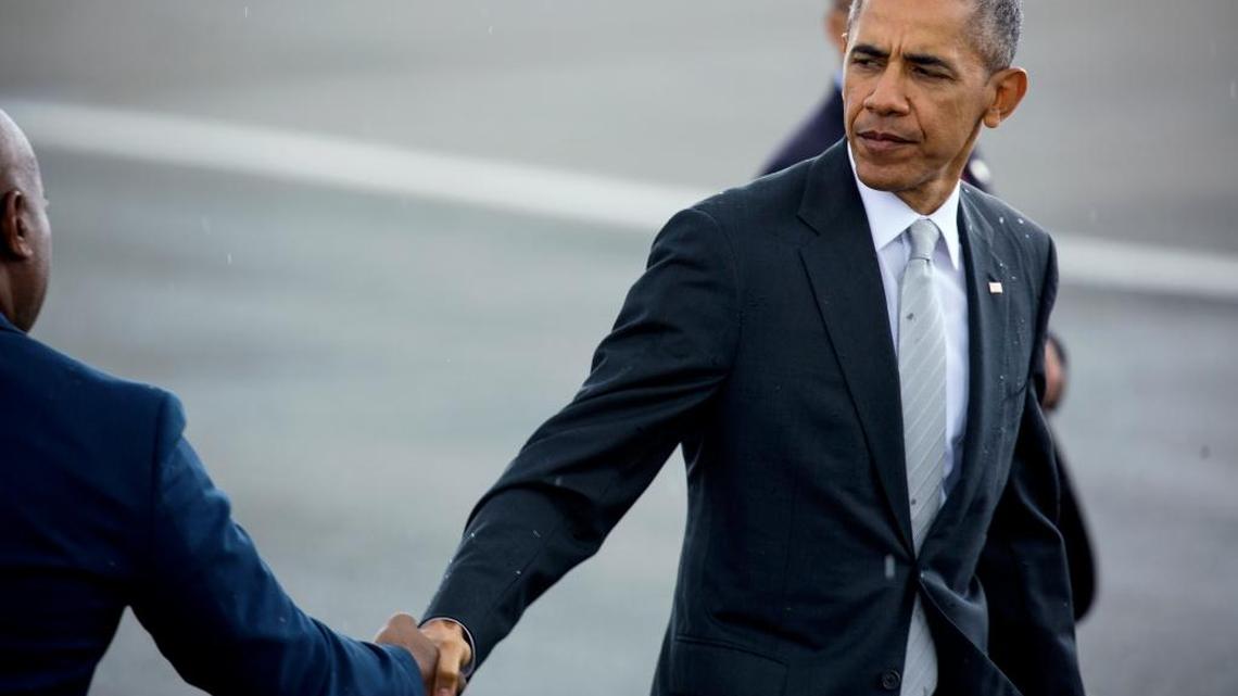 President Barack Obama shakes hands with Newark Mayor Ras Baraka after arriving at Newark Liberty International Airport in Newark, N.J., Sunday, May 15, 2016. Obama shortly after departed to deliver a commencement address at Rutgers University.
