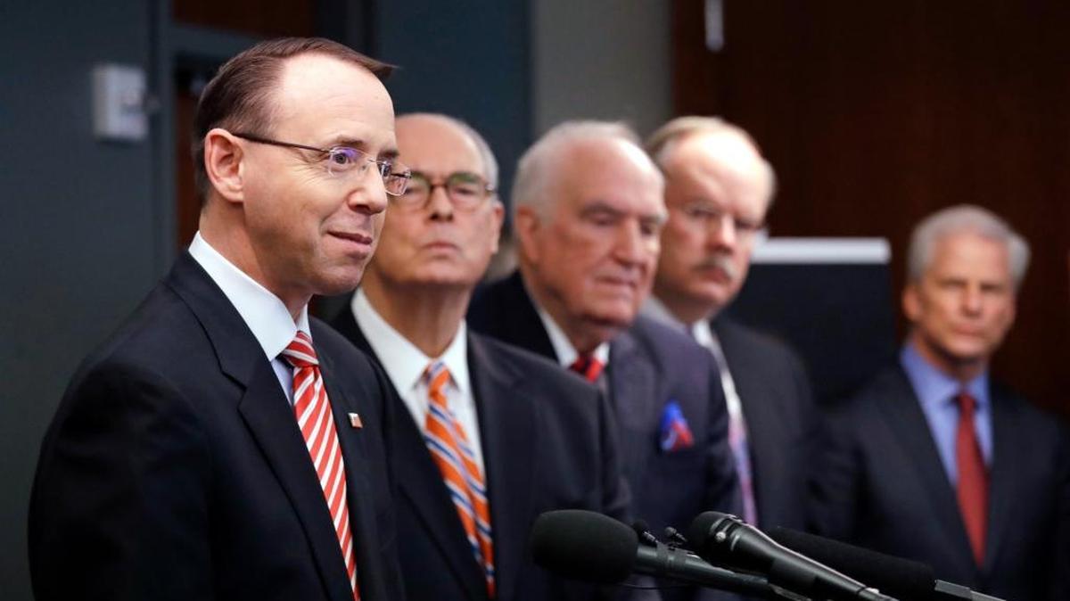 Deputy Attorney General Rod Rosenstein, left, speaks at a news conference giving an update on the unsolved 2001 slaying of a federal prosecutor, Wednesday, Feb. 21, 2018, in Seattle. Behind him stand former U.S. Attorneys John McKay, right, Bill Hyslop, Hal Hardin and Mike McKay. Rosenstein joined other officials to discuss the killing of Assistant United States Attorney Thomas Wales, an 18-year veteran of the U.S. Attorney's Office in Seattle who was shot as he worked in the basement of his home on Oct. 11, 2001. (AP Photo/Elaine Thompson)