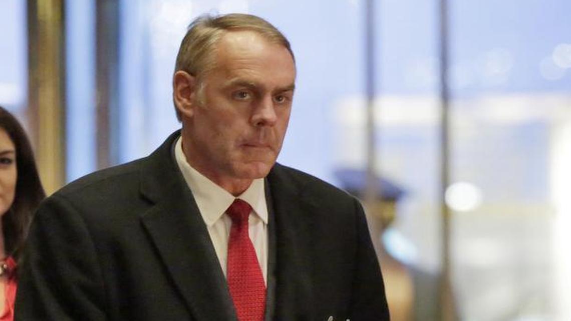 Rep. Ryan Zinke, right, R-Mont., President-elect Donald Trump's choice for interior secretary, arrives at Trump Tower in New York on Dec. 12.