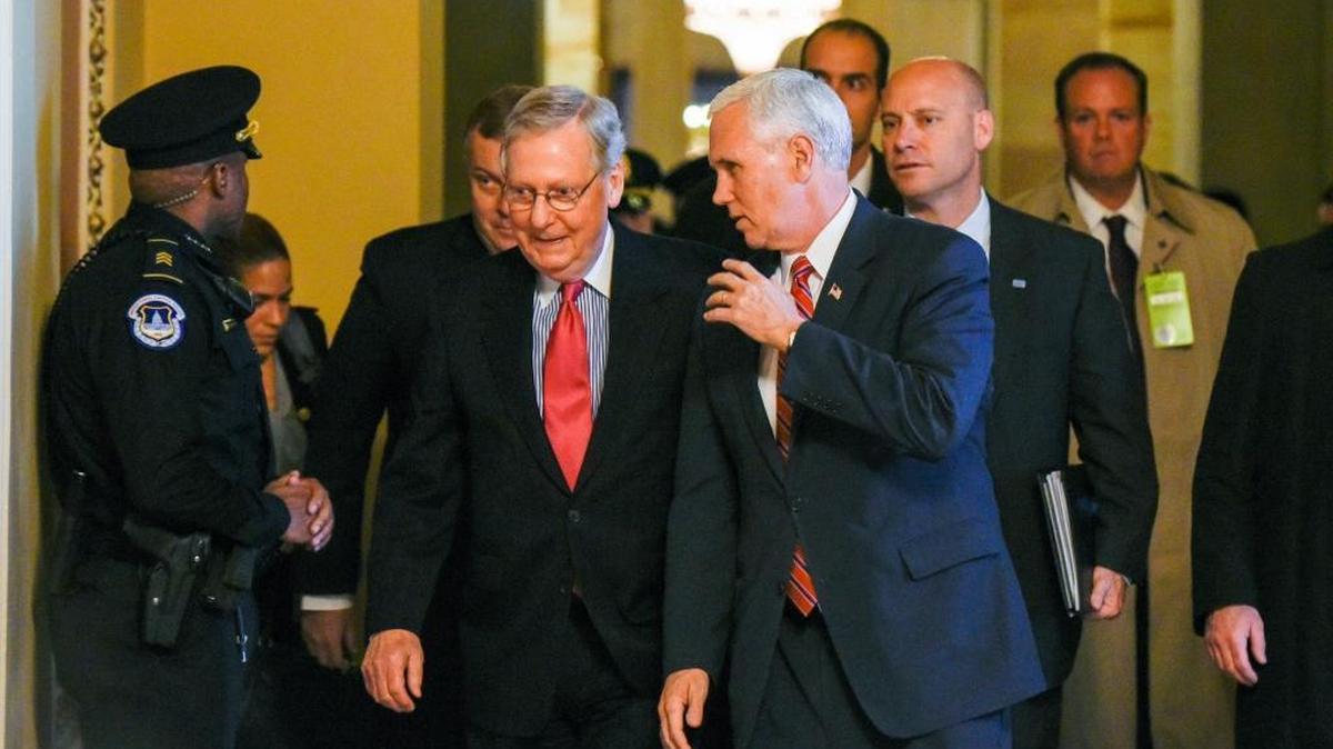 Vice President-elect Mike Pence talks with Senate Majority Leader Mitch McConnell of Kentucky as they walk on Capitol Hill in Washington Tuesday.