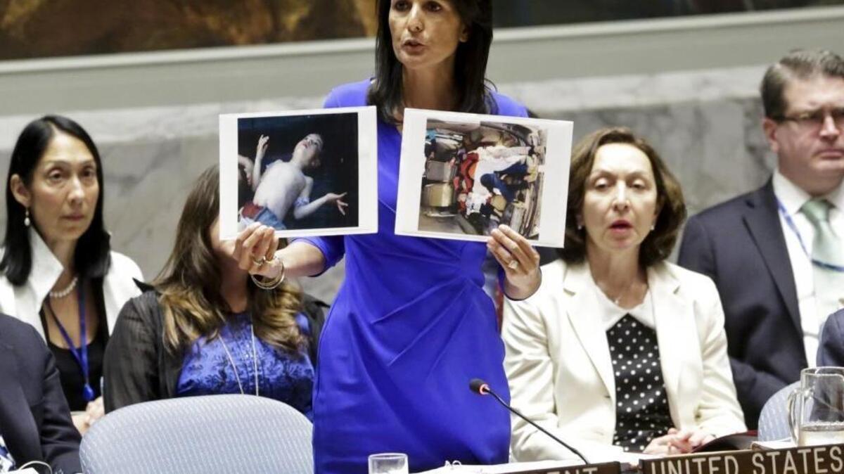 Nikki Haley, the U.S. ambassador to the United Nations, shows pictures of Syrian victims of chemical attacks as she addresses a meeting of the Security Council on Syria at U.N. headquarters, Wednesday, April 5, 2017.