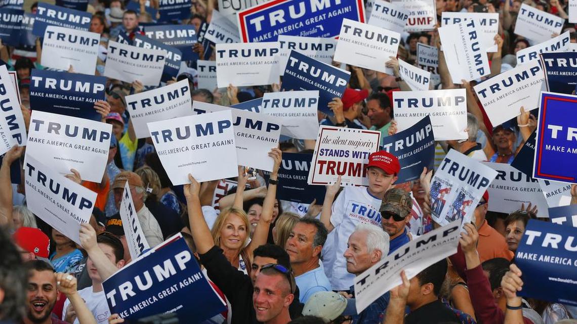 Audience members hold up signs supporting Republican presidential candidate Donald Trump during a campaign rally in Boca Raton, Fla., Sunday, March 13, 2016.