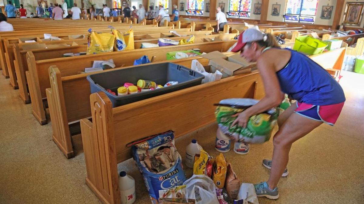 Palm City resident Sandy Burton drops off donated items during a Mass held for about 30 people on Sunday at San Pablo Catholic Church on Marathon Key, Fla. The church is also serving as a donation drop-off site for food, water and other basic necessities and has no electricity, but is structurally sound.