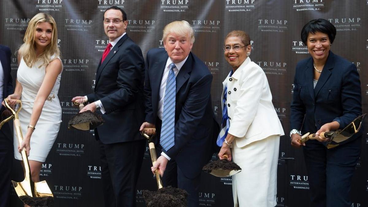 Donald Trump, center, poses for photographs during a ground breaking ceremony for the Trump International Hotel on the site of the Old Post Office, on Wednesday, July 23, 2014, in Washington. From left, Ivanka Trump, Washington Mayor Vincent Gray, Trump, Del. Eleanor Holmes Norton, D-D.C., and Muriel Bowser, the Democratic nominee for D.C. mayor. (AP Photo)