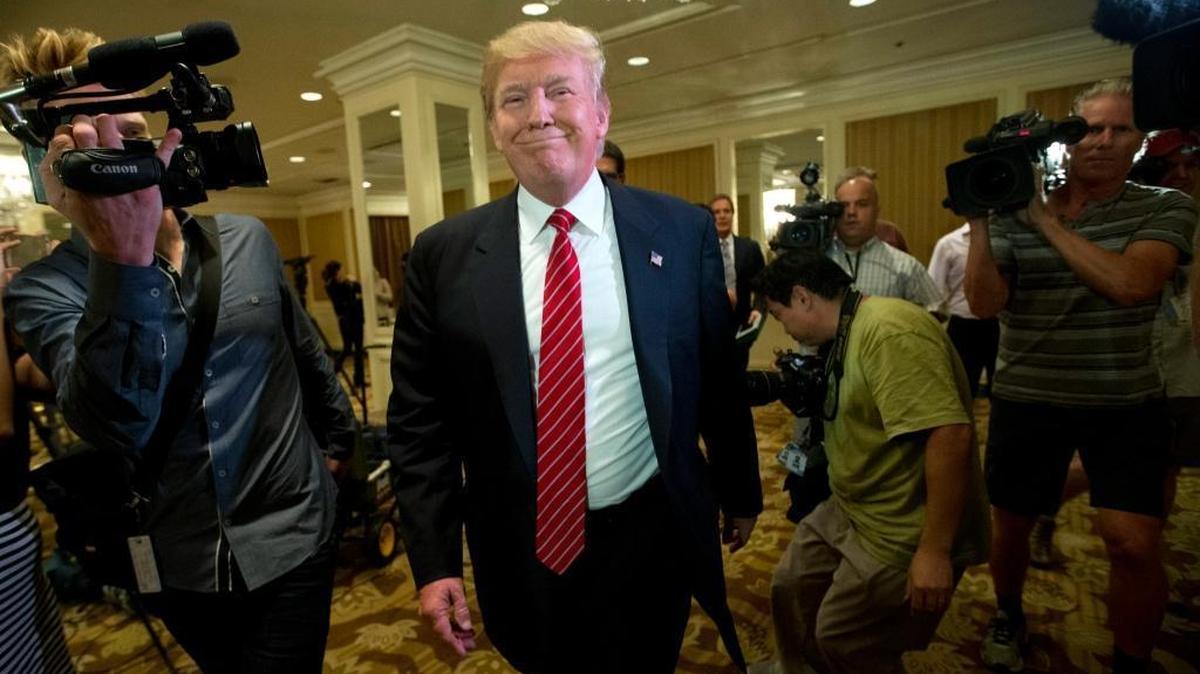 In this July 10, 2015 file photo, Republican presidential candidate Donald Trump smiles as he leaves after speaking at a news conference about immigration, in Beverly Hills, Calif. California Democrats hope to cash in at the polls against Republican members of Congress considered vulnerable to Latino sentiment against Trump.