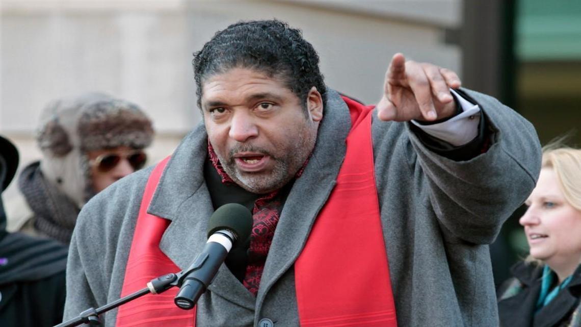 Rev. William Barber urges HKonJ march protesters to both donate to the cause and get in their march groups at the end of the rally portion in front of Memorial Auditorium in downtown Raleigh, NC Saturday morning, February 13, 2016.