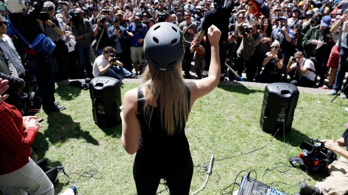 Lauren Southern wears a protective helmet as she speaks during a rally for free speech Thursday, April 27, 2017, in Berkeley, Calif. Demonstrators gathered near the University of California, Berkeley campus amid a strong police presence and rallied to show support for free speech and condemn the views of Ann Coulter and her supporters.