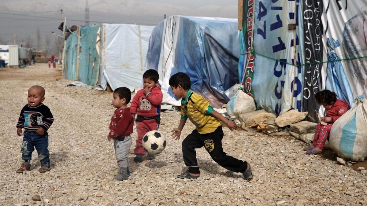 Syrian refugee children play outside their family tents in a camp in the town of Saadnayel, in the Bekaa valley, Lebanon, Friday, Jan. 22, 2016.