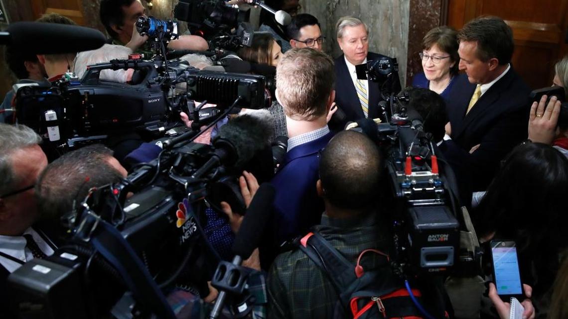 Sen. Lindsey Graham, R-S.C., back left, Sen. Susan Collins, R-Maine, and Sen. Jeff Flake, R-Ariz., speak to the media after attending a bipartisan meeting of senators.