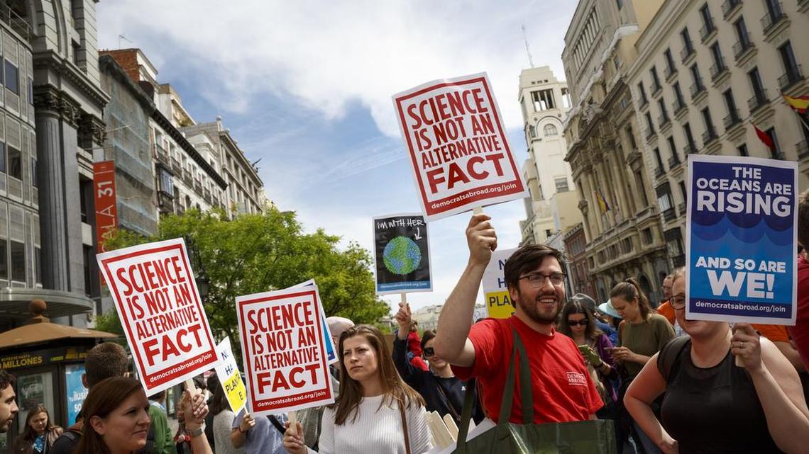 People protest holding banners at the March for Science event in Madrid, Saturday, April 22, 2017. Thousands of scientists worldwide left their labs to take to the streets Saturday along with students and research advocates in pushing back against what they say are mounting attacks on science.