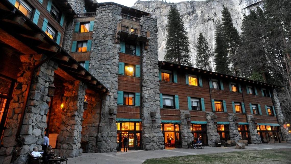 The historic Ahwahnee Hotel, lit up as dusk falls over Yosemite Valley, is at the center of a trademarked name dispute.
