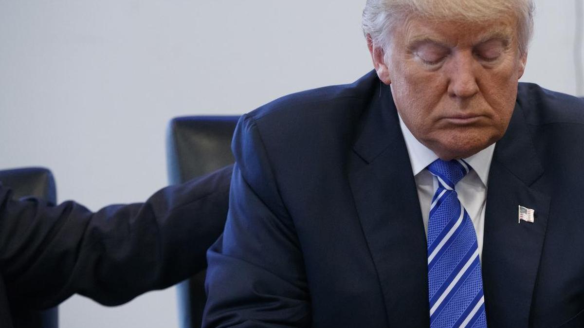 File-This Oct. 7, 2016, file photo shows Republican presidential candidate Donald Trump pausing during a meeting with members of the National Border Patrol Council at Trump Tower in New York. )