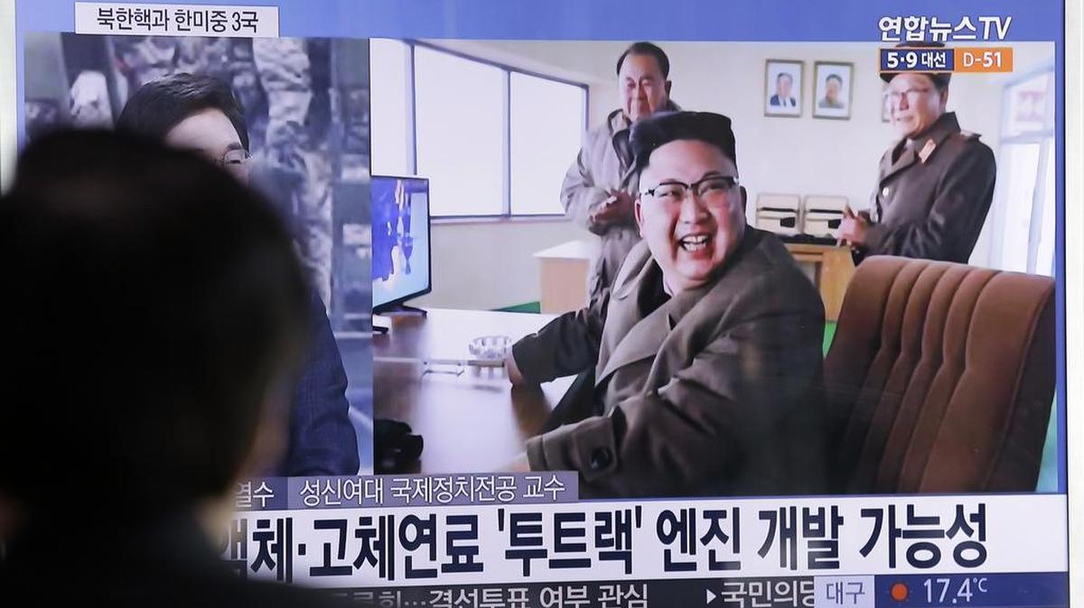North Korean leader Kim Jong Un reacts to the successful test March 19 of a new type of high-thrust rocket engine. The letters read “New type engine.”