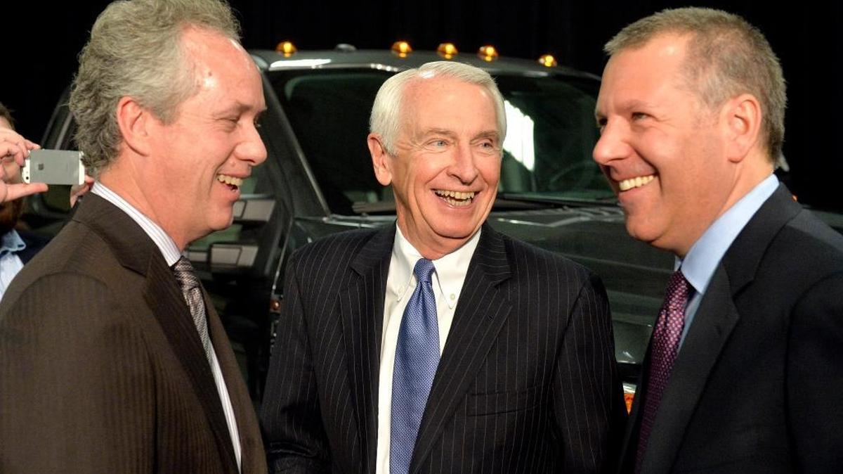 Louisville, Ky., Mayor Greg Fischer, left, Kentucky Gov. Steve Beshear, center, and Ford President of the Americas Joe Hinrichs share a laugh following the announcement that the Ford Motor Co. will be adding 2,000 jobs and investing $1.3 billion at the Kentucky Truck Plant in Louisville to build the new aluminum-body Super Duty truck, Dec. 1, 2015.