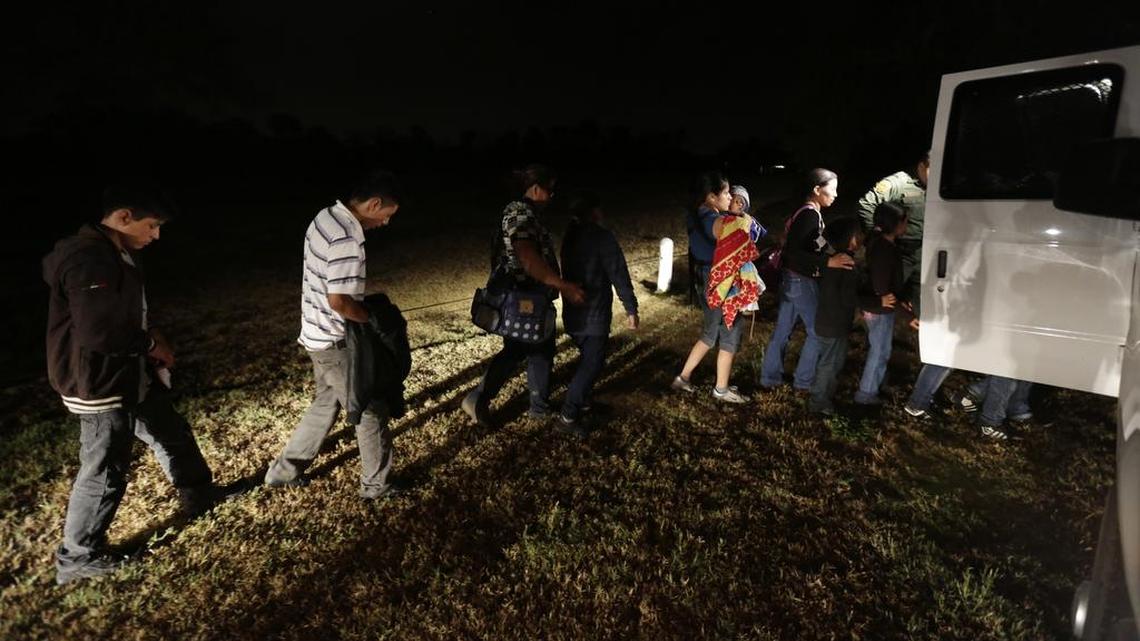 A group of immigrants from Honduras and El Salvador who crossed the U.S.-Mexico border illegally are loaded onto a van in Granjeno, Texas, on June 25, 2014.