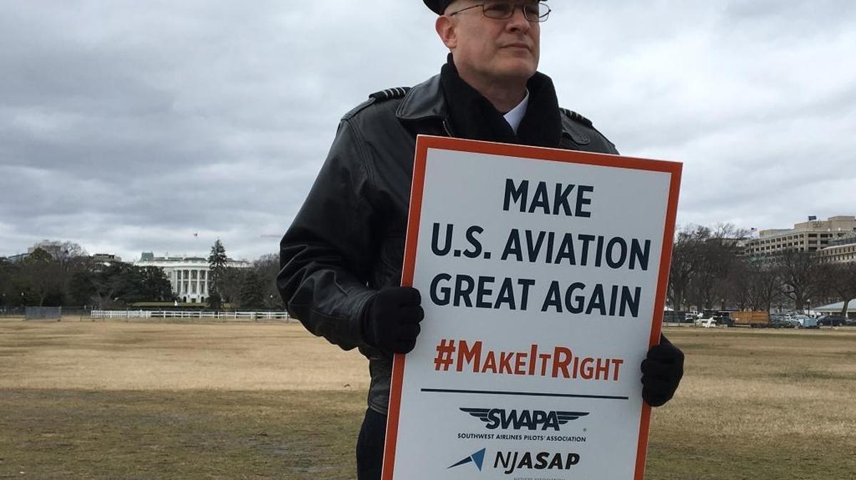 Southwest Airlines pilot Mike Panebianco rallies outside the White House on Tuesday, Jan. 24, 2017, to urge President Donald Trump to overturn an agreement that gives Norwegian Air additional U.S. routes. Airline unions say the Norwegian deal will lead to fewer American jobs.