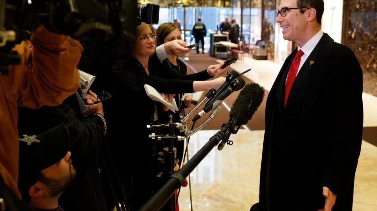 Steven Mnuchin, President-elect Donald Trump's nominee for treasury secretary, talks with reporters in the lobby of Trump Tower, Wednesday, Nov. 30, 2016, in New York.