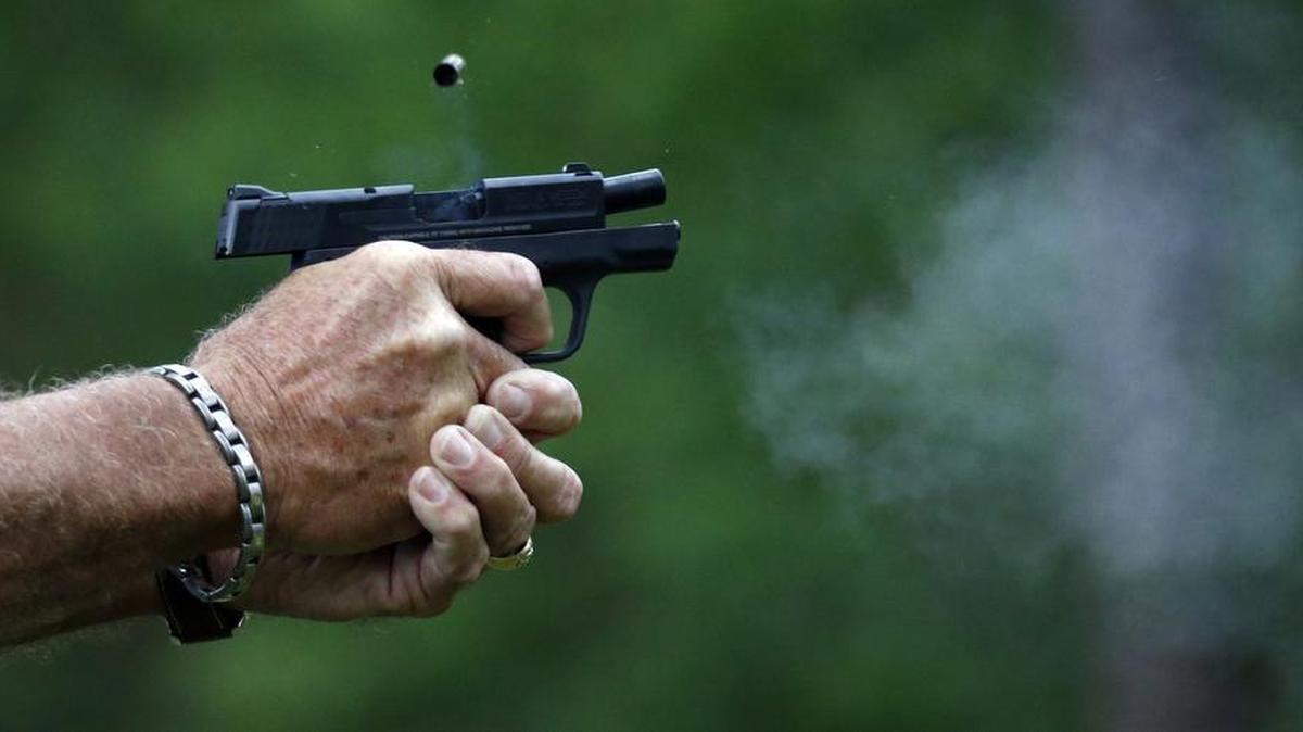 In this April 30, 2016 photograph, gun smoke and a spent round is ejected from a participant's automatic handgun during the live fire portion of a enhanced concealed carry class sponsored by Crestview Baptist Church for members and area residents in Petal, Miss. The 20 participants received hands on assistance during a practical shooting exercise, a thorough review on the fundamentals of safe handling of firearms in addition to a review of the basic and enhanced Mississippi Concealed Carry laws.