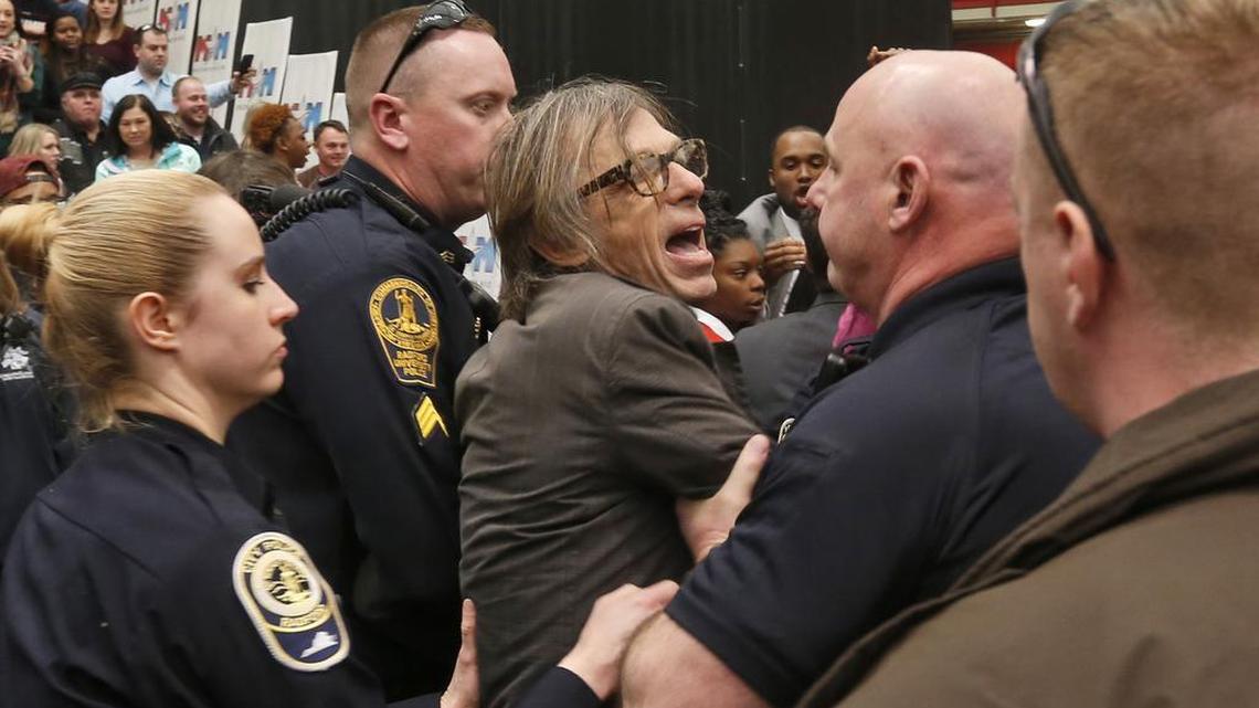 Photojournalist Christopher Morris is escorted by police during the rally of Republican presidential candidate, Donald Trump on Monday at Radford University in Radford, Va.