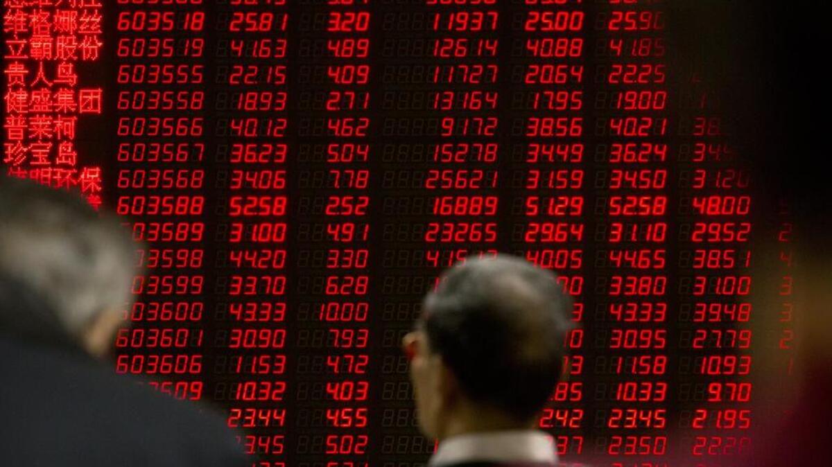 Chinese investors monitor stock prices at a brokerage house in Beijing, Friday, Jan. 29, 2016. Slower economic growth in China has cut its demand for steel and the coal used to make it.