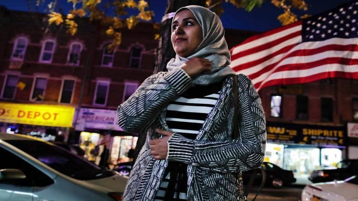 Enas Almadhwahi, an immigration outreach organizer for the Arab American Association of New York, stands for a photo along Fifth Avenue in the Bay Ridge neighborhood of Brooklyn on Nov. 11, 2016, in New York. American Muslims are reeling over Donald Trump's victory, wondering what the next four years will bring after a campaign in which he proposed creating a national database of Muslims, monitoring all mosques and banning some or all Muslims from entering the country.