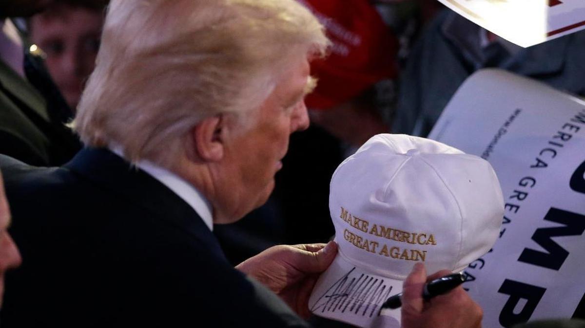Republican presidential candidate Donald Trump autographs a hat during a campaign stop Wednesday, April 27, 2016, in Indianapolis.