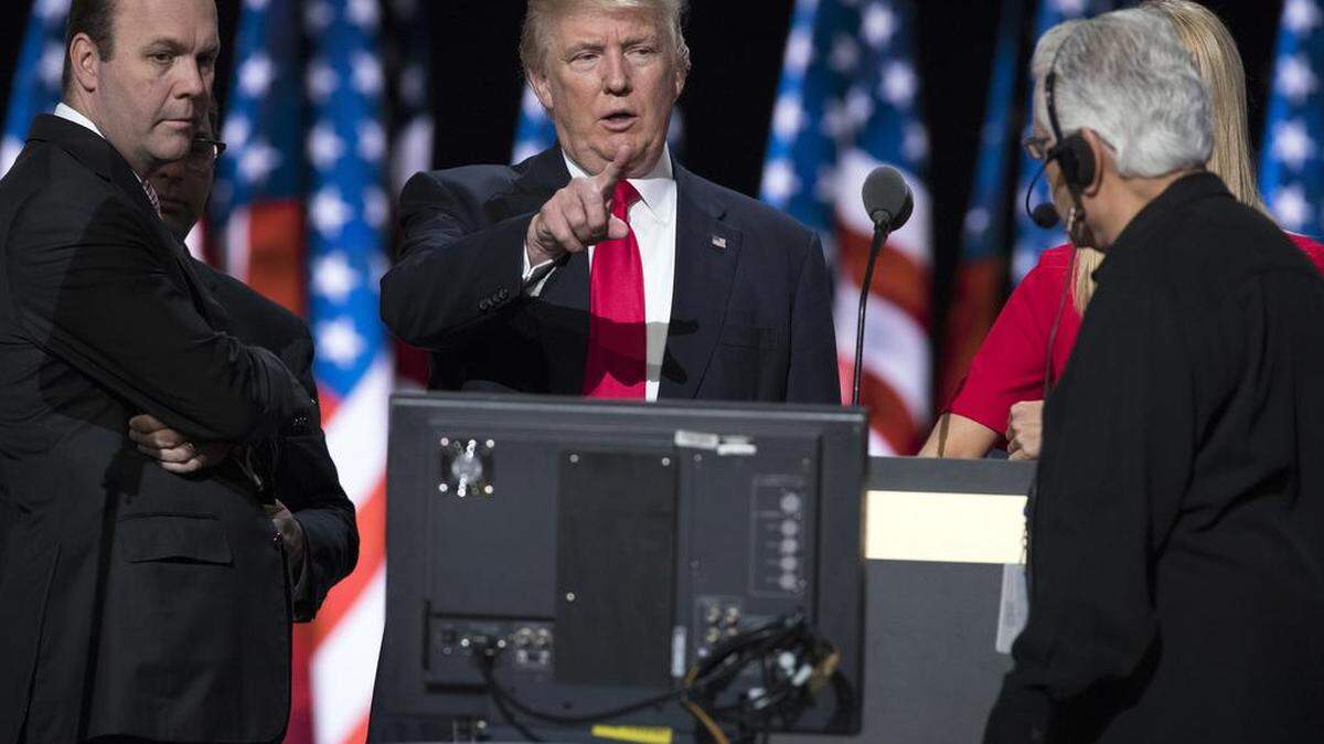 In this July 21, 2016 file photo, Republican presidential candidate Donald Trump, center, accompanied by Trump campaign aide Rick Gates, left, prepares for his speech at the Republican National Convention in Cleveland. 