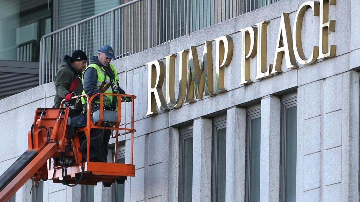 Workmen remove the letters from a building formerly known as Trump Place in New York. Donald Trump's name is being stripped off three luxury apartment buildings after hundreds of tenants signed a petition saying they were embarrassed to live in a place associated with the Republican President-elect.