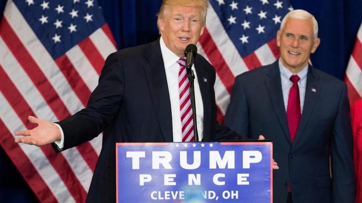 Vice presidential running mate Gov. Mike Pence, R-Ind., right, listens as Republican presidential candidate Donald Trump speaks during an goodbye reception with friends and family following the Republican National Convention Friday in Cleveland.
