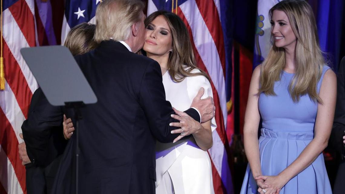 President-elect Donald Trump kisses his wife Melania Trump as his daughter Ivanka Trump watches after giving his acceptance speech during his election night rally, Wednesday, Nov. 9, 2016, in New York. At left is thier son Barron Trump.
