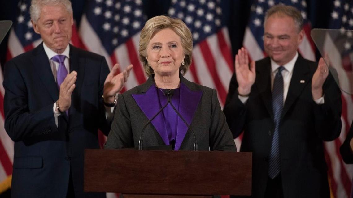 Former President Bill Clinton and Sen. Tim Kaine, D-Va. applaud as Democratic presidential candidate Hillary Clinton speaks in New York, Wednesday, Nov. 9, 2016, where she conceded her defeat to Republican Donald Trump after the hard-fought presidential election.