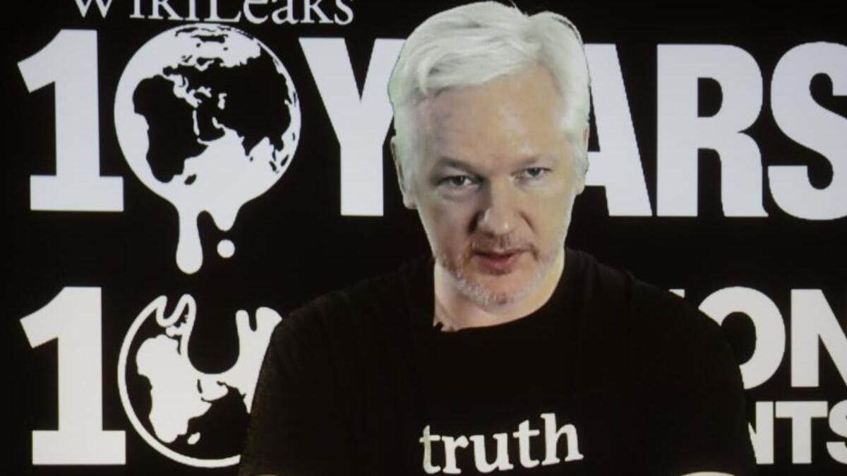 FILE - In this Oct. 4, 2016 file photo, WikiLeaks founder Julian Assange participates via video link at a news conference marking the 10th anniversary of the secrecy-spilling group in Berlin. Assange may be stuck in the Ecuadorean Embassy and cut off from the internet, but he's closer than ever to testing a hypothesis he first outlined nearly a decade ago. Can total transparency defeat an entrenched group of insiders?