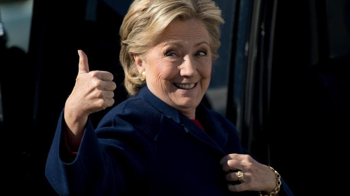 Democratic presidential candidate Hillary Clinton gives a thumbs up to a member of the media as she arrives to board her campaign plane at Westchester County Airport in White Plains, N.Y., Tuesday, Oct. 25, 2016, to travel to Fort Lauderdale, Fla., for a rally.