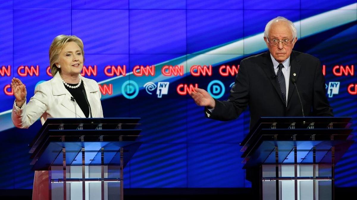 Democratic presidential candidate Sen. Bernie Sanders, I-Vt., right, gestures while Hillary Clinton speaks during the CNN Democratic Presidential Primary Debate at the Brooklyn Navy Yard Thursday, April 14, 2016, New York.