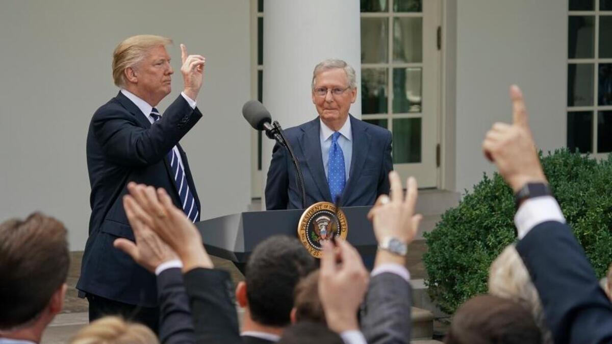 Journalist raise their hands as they wait to called on to ask a question to President Donald Trump and Senate Majority Leader Mitch McConnell of Ky., in the Rose Garden of the White House, Monday, Oct. 16, 2017.