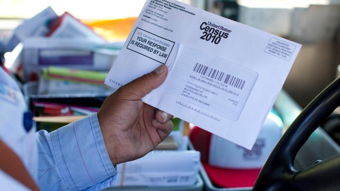 US Postal Service mail carrier Thomas Russell holds a census form while working his route. US census advocates held a rally Saturday, April 10, 2010 at the Mas Jid Ash-Shaheed mosque in Charlotte, NC to convince people to fill out the 2010 census form.
