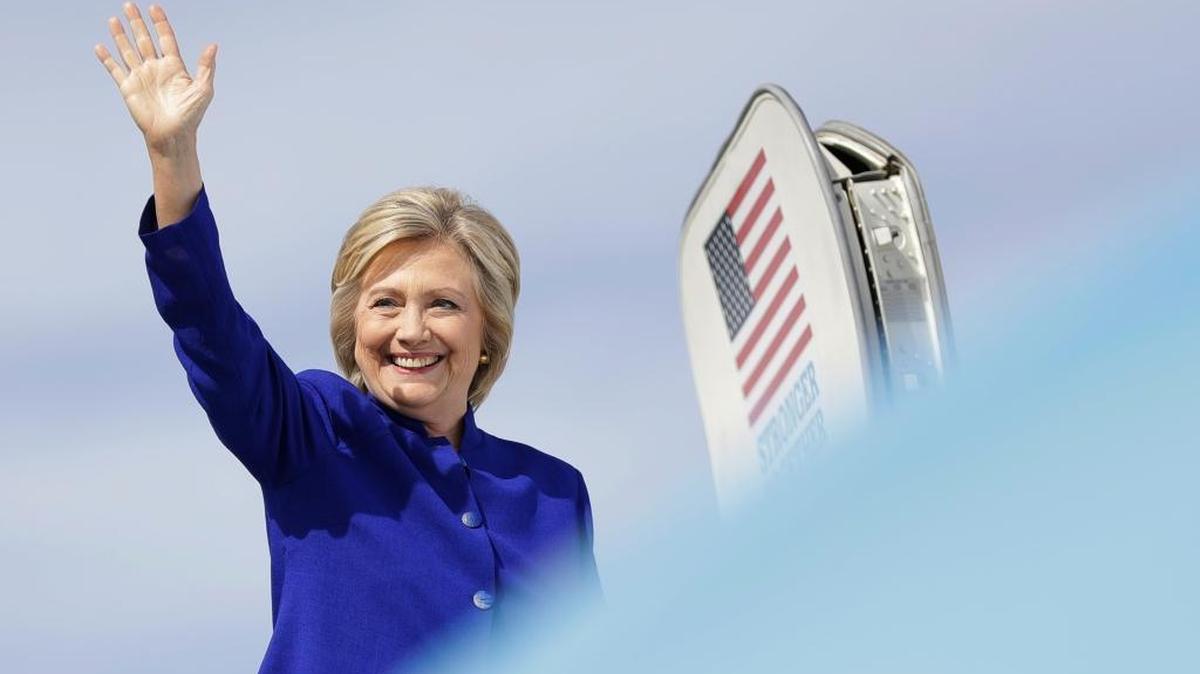 Democratic presidential candidate Hillary Clinton waves as she boards her campaign plane at Westchester County Airport in White Plains, N.Y., Wednesday, Sept. 21, 2016.