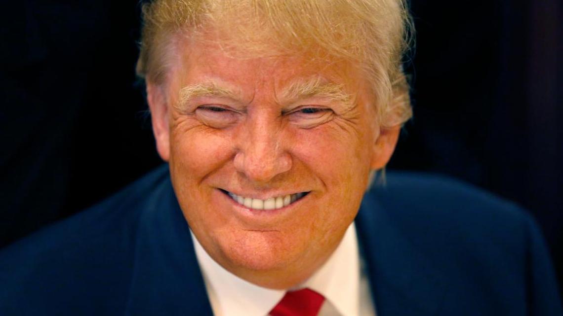 Republican presidential candidate Donald Trump smiles for a photographer before he addresses members of the City Club of Chicago on June 29.