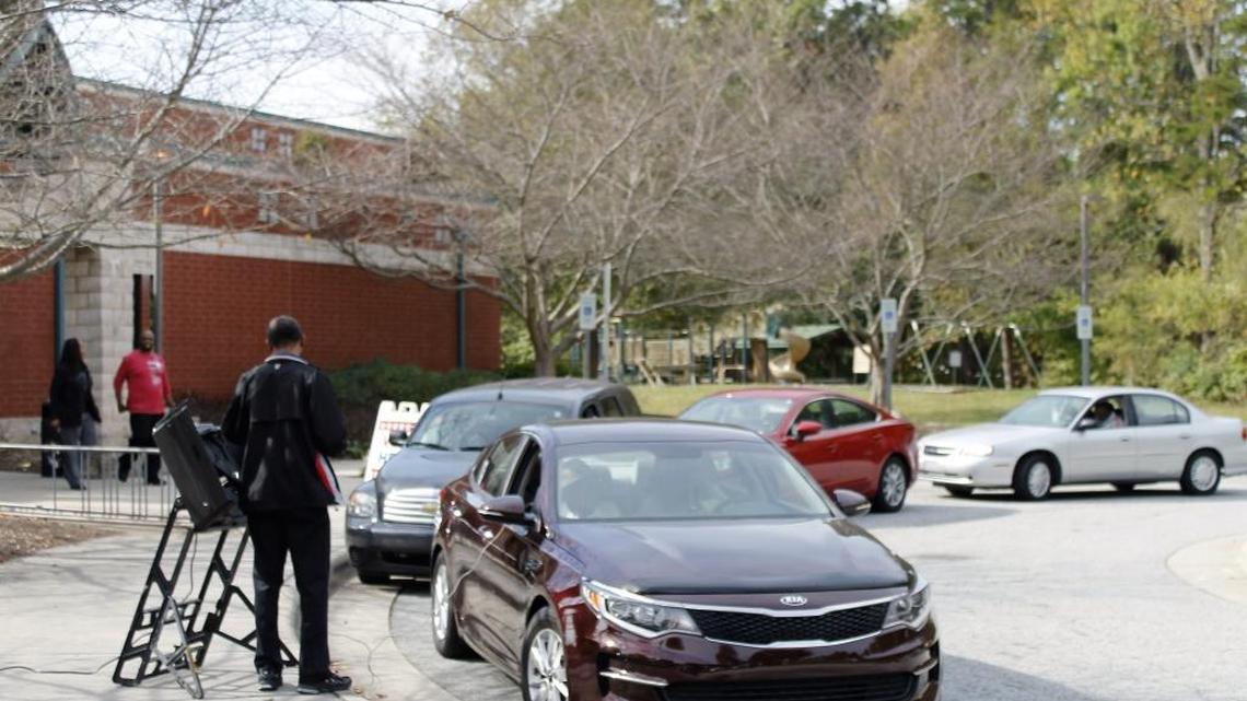 Voters at Brown Recreation Center in Greensboro, North Carolina, take advantage of curbside voting on Thursday, Oct. 27, 2016, which marked the first day of early voting in Guilford County.