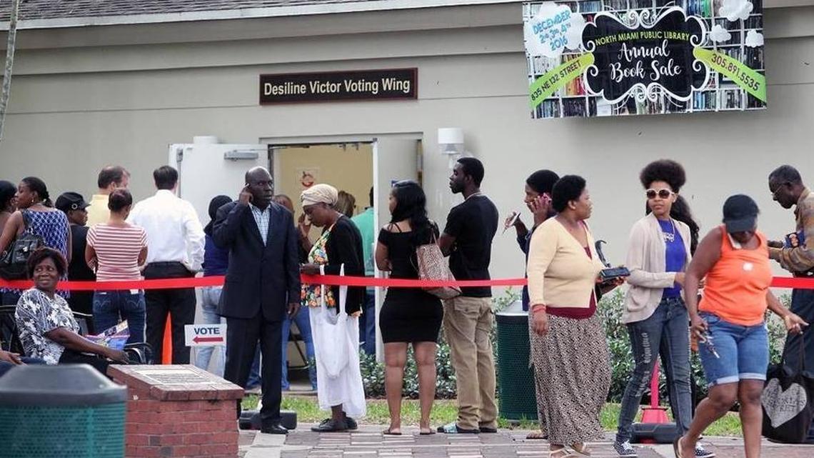 Voters stand in line outside the North Miami Public Library waiting to cast ballots during early voting, Friday, Nov. 4, 2016.